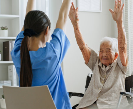 caregiver exercising with senior