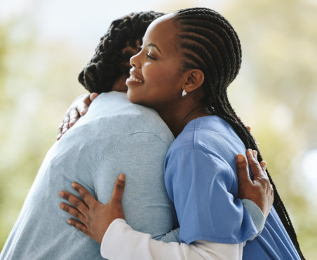 caregiver hugging senior
