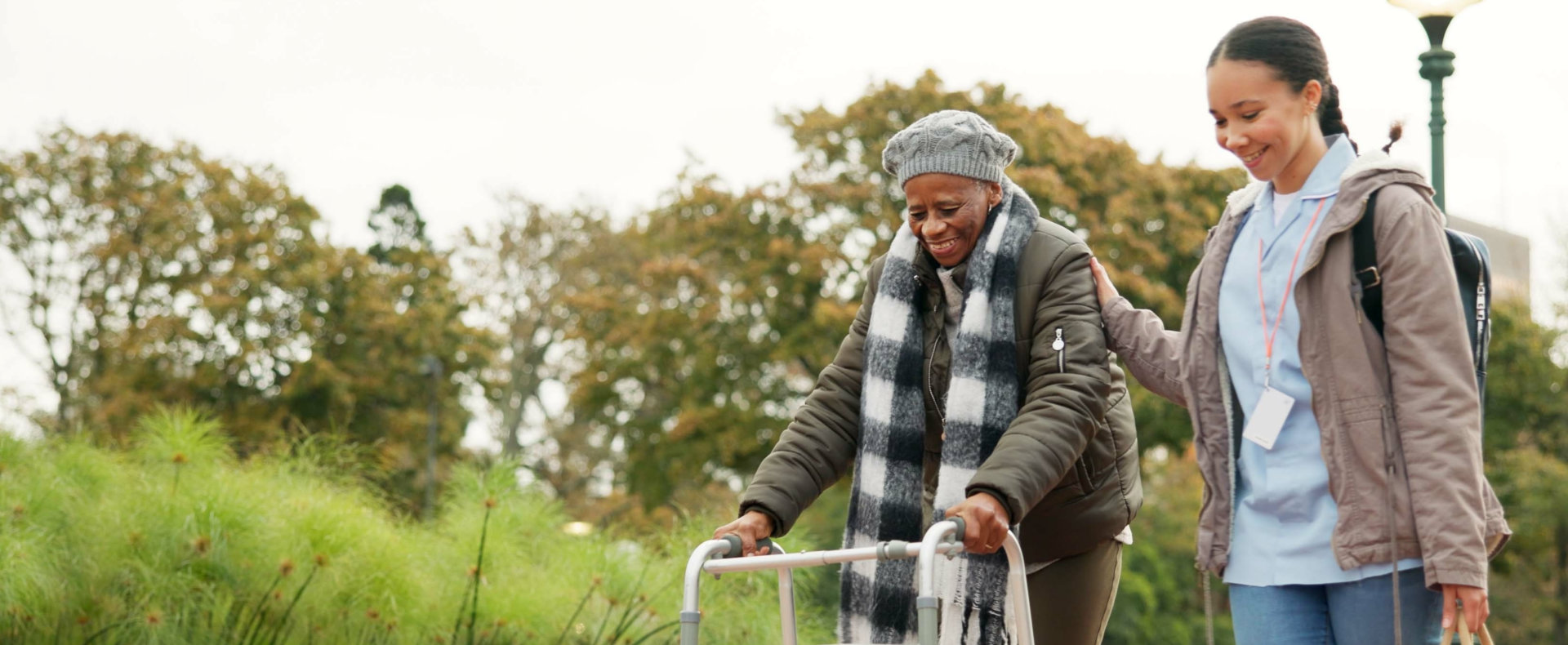 caregiver walking together with senior