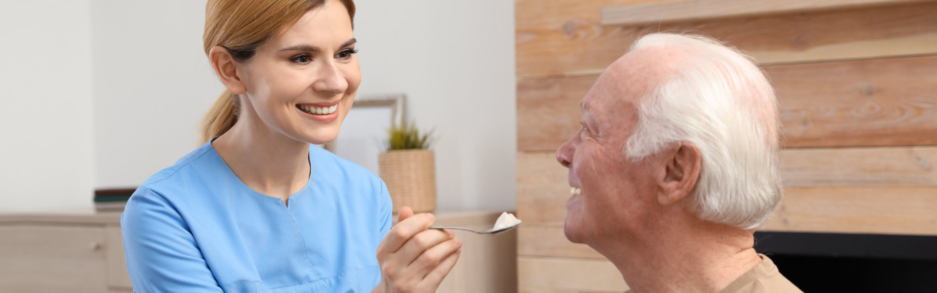 Caregiver feeding elderly