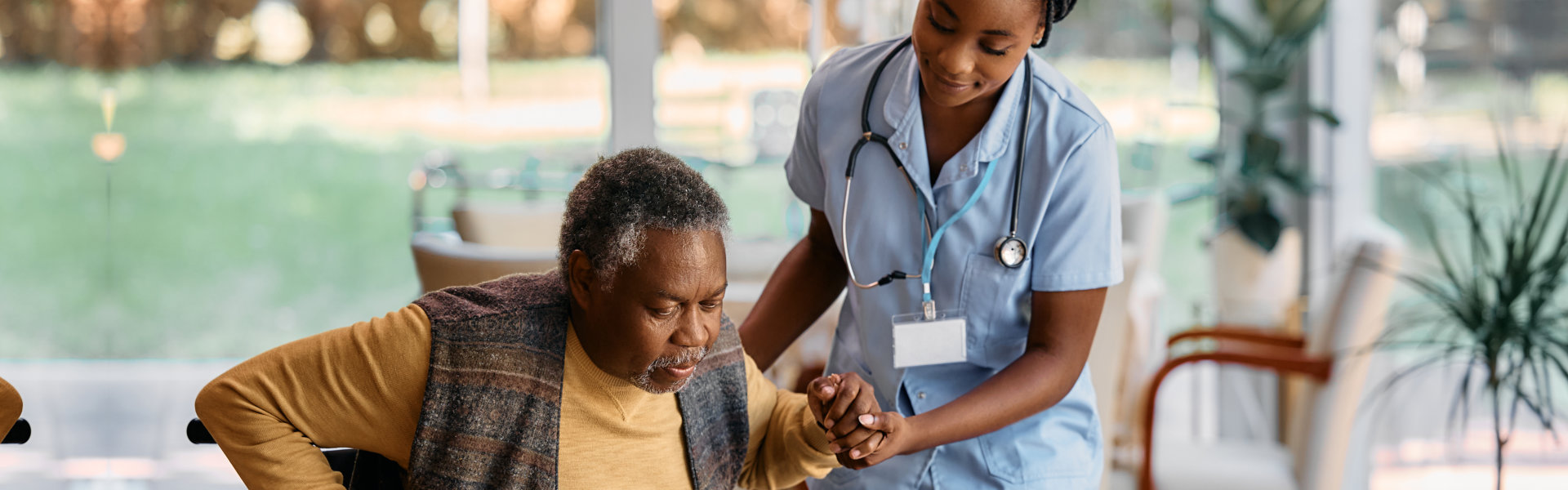 caregiver assisting senior man